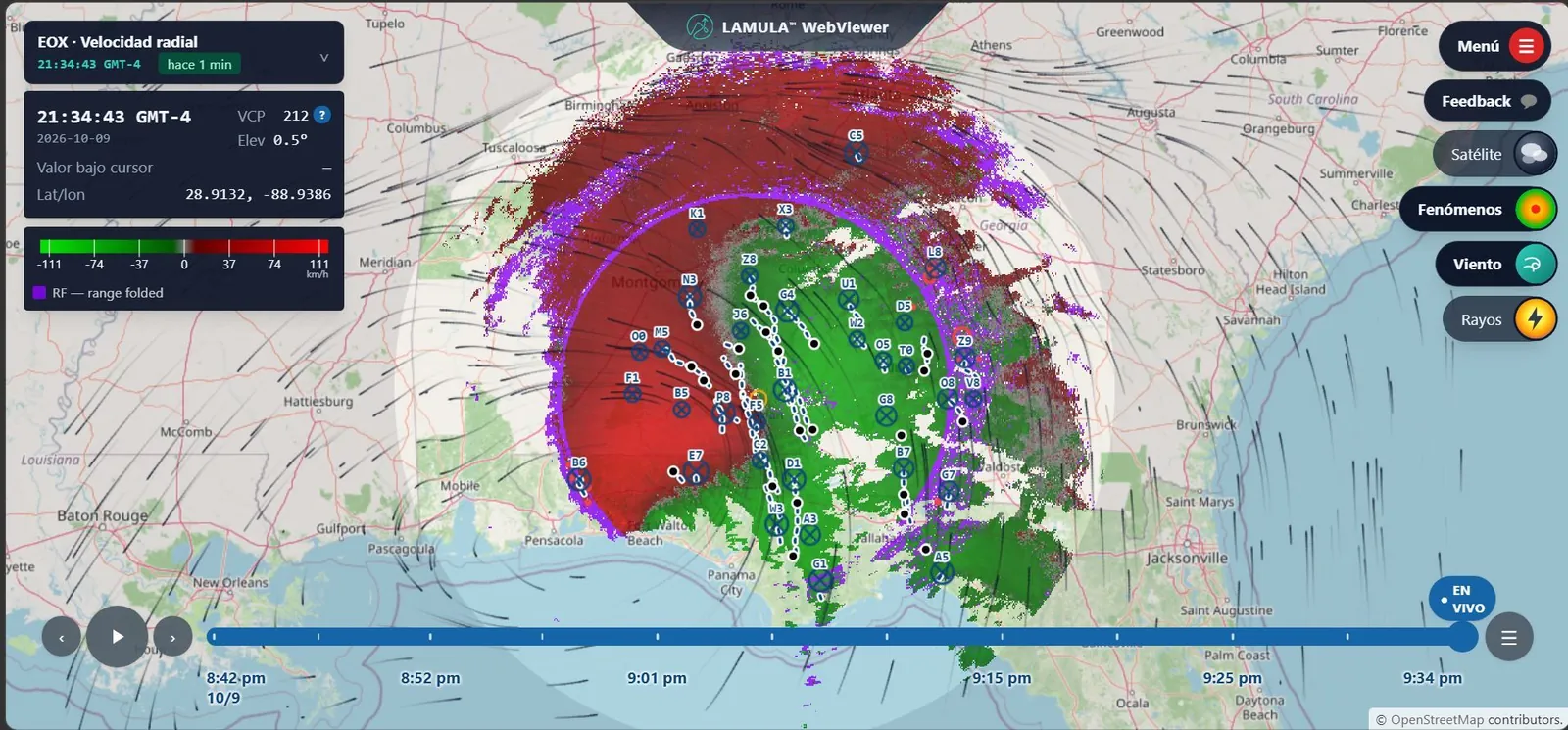 The same viewer showing radial velocity: a red lobe north-west of the radar and a green one south-east of it, on a colour scale running from −111 to 111 km/h, ringed by a purple arc labelled range folded. Storm cell identifiers, wind barbs and a volume timeline run along the bottom of the window.